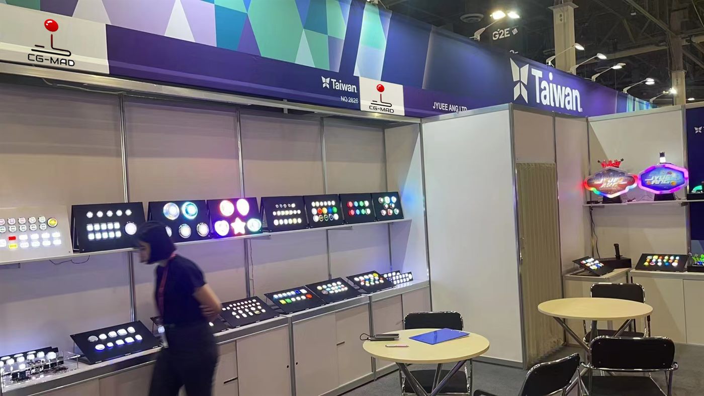 Wider view of the CGMAD stand at G2E Asia, with control panels along the counter