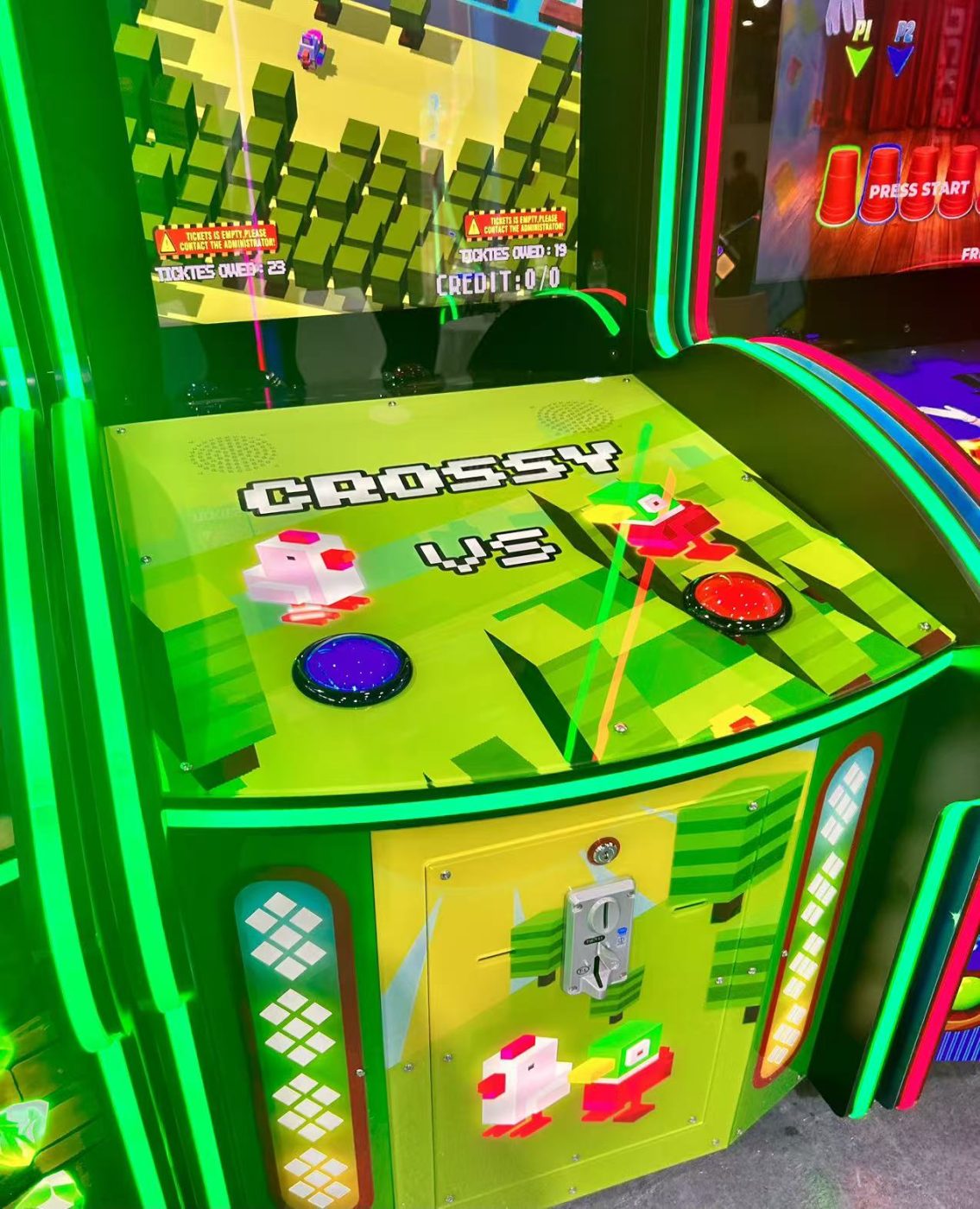 Two-player video cabinet with one large blue and one large red dome button on the panel