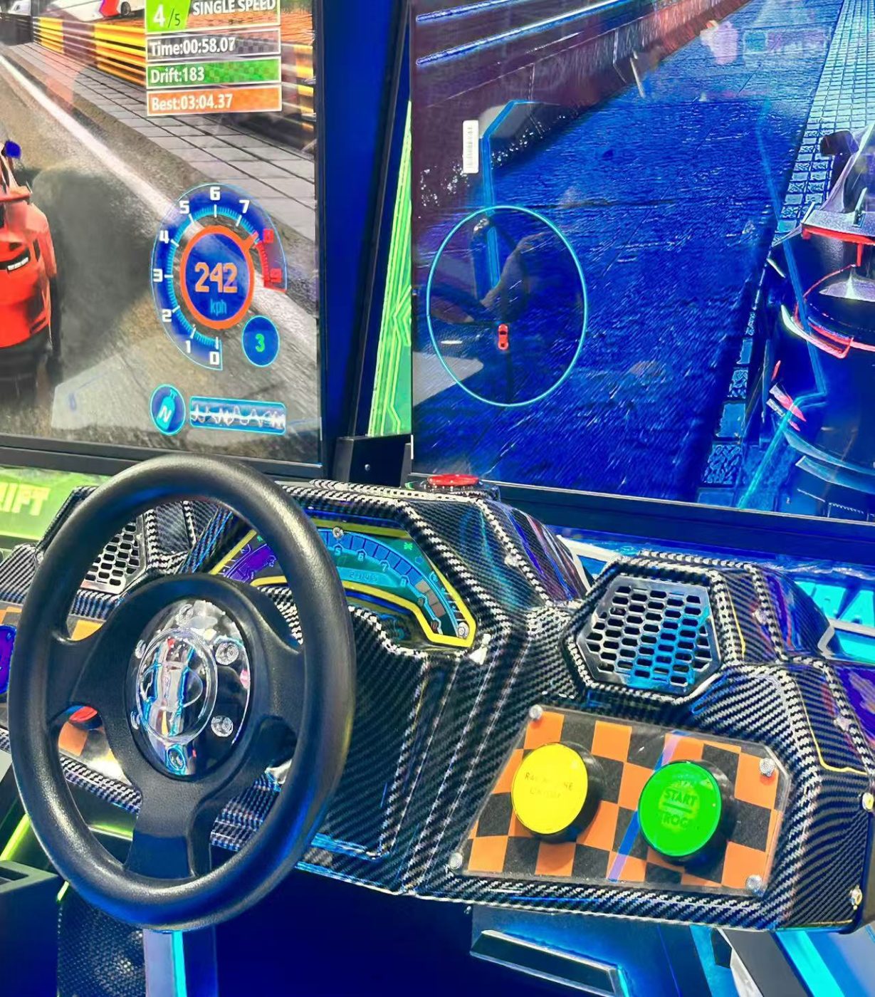 Driving cabinet steering wheel with yellow and green illuminated start buttons beside it